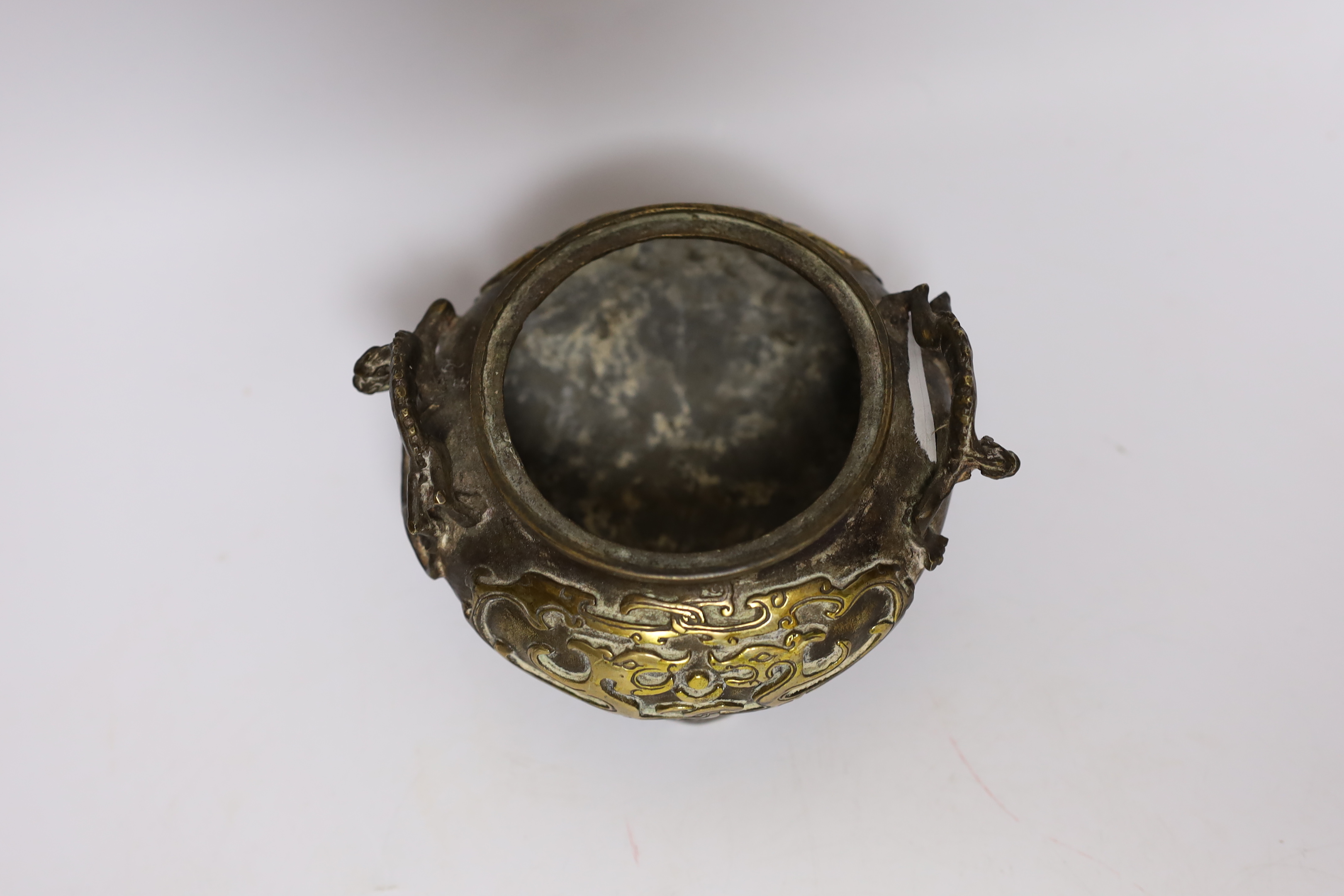 A Chinese parcel gilt bronze censer, with pierced lid and twin zoomorphic handles, 15cm high